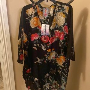 Johnny was colorful floral blouse with red roses and birds.